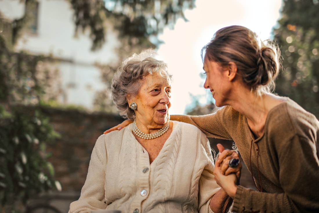Young woman laughing with elderly patient